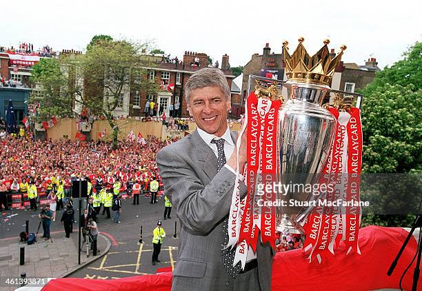 Arsenal manager Arsene Wenger holds the Premier League trophy at Islington Town Hall on May 19, 2004 in London, England.