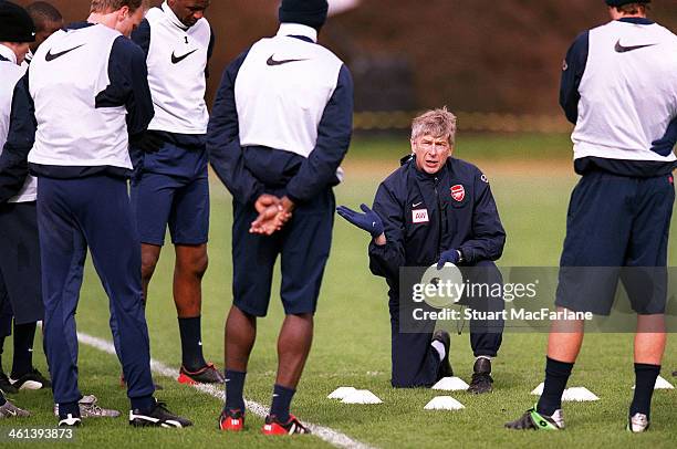 Arsenal manager Arsene Wenger talks to his players during a training session at London Colney on March 15, 2004 in St Albans, England.
