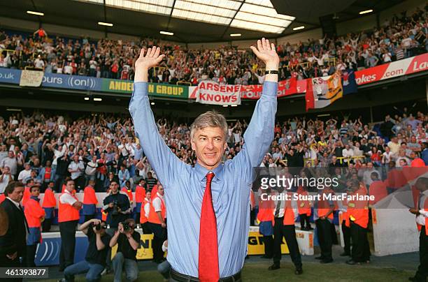 Manager Arsene Wenger celebrates Arsenal winning the Premier League after the match between Tottenham and Arsenal at White Hart Lane on April 25,...