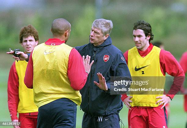 Arsenal manager Arsene Wenger talks to Thierry Henry during a training session on May 6, 2005 in London, England.