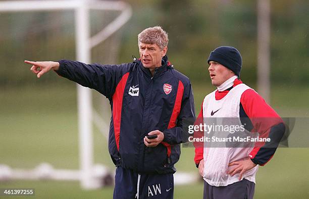 Arsenal manager Arsene Wenger with Freddie Ljungberg during a training session at London Colney on April 15, 2003 in St Albans, England.