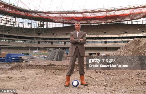 Arsenal manager Arsene Wenger stands on the centre spot of Emirates stadium during construction on August 15, 2005 in London, England.