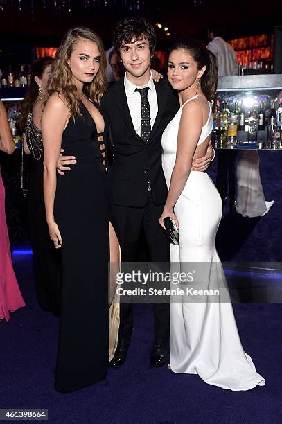 Model Cara Delevingne and actors Nat Wolff and Selena Gomez attend the 2015 InStyle And Warner Bros. 72nd Annual Golden Globe Awards Post-Party at...
