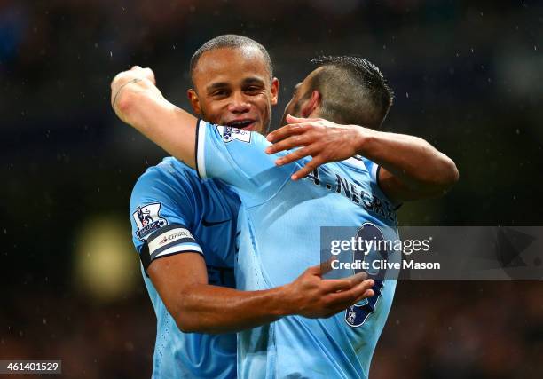 Vincent Kompany of Manchester City congratulates Alvaro Negredo of Manchester City on scoring his second goal during the Capital One Cup Semi-Final...