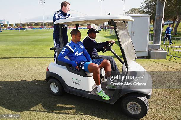 Dennis Aogo leaves the training ground in a golf cart during day 7 of the FC Schalke 04 training camp at the ASPIRE Academy for Sports Excellence on...