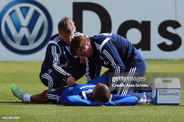 Dennis Aogo receives treatment during day 7 of the FC Schalke 04 training camp at the ASPIRE Academy for Sports Excellence on January 12, 2015 in...