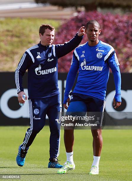 Dennis Aogo hobbles next to physiotherapist Thomas Kuehn during day 7 of the FC Schalke 04 training camp at the ASPIRE Academy for Sports Excellence...