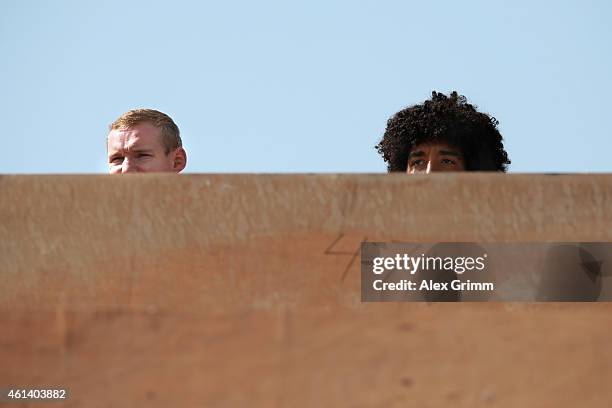 Sebastian Rode and Dante of Bayern Muenchen watch the Schalke training session during day 7 of the FC Schalke 04 training camp at the ASPIRE Academy...