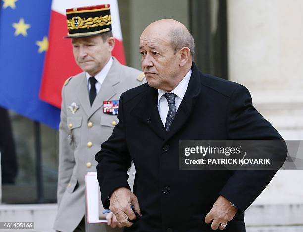 French Defence Minister Jean-Yves Le Drian flanked by French Army Chief of Staff General Pierre de Villiers, leaves the Elysee Palace after a...