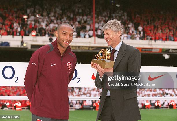 Arsenal manager Arsene Wenger presents striker Thierry Henry with the Golden boot after the match between Arsenal and Wigan Athletic, the last match...