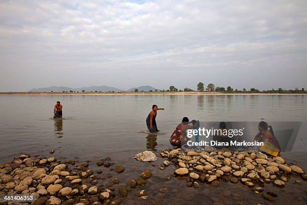 Residents from Kachin state bathe in the Irrawaddy River at sunset on December 28, 2013 in Kachin State, Myanmar. The Irrawaddy River is the lifeline...