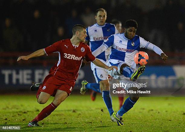 Jamie Proctor of Crawley challenges Ellis Harrison of Bristol Rovers during the FA Cup Second Round Replay between Crawley Town and Bristol Rovers at...