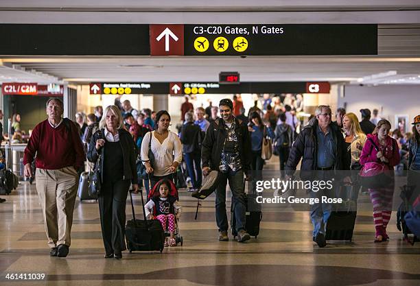 Passengers in the C Terminal at Seattle-Tacoma International Airport head to their gates on June 2 in Seattle, Washington. Seattle, located in King...