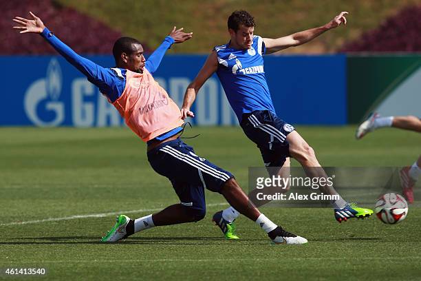Tranquillo Barnetta is challenged by Felipe Santana during day 7 of the FC Schalke 04 training camp at the ASPIRE Academy for Sports Excellence on...