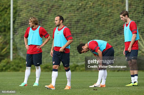 Chance Myers, Landon Donovan, Benny Feilhaber and Clarence Goodson of the U.S. Men's National Soccer team take a break during training at StubHub...