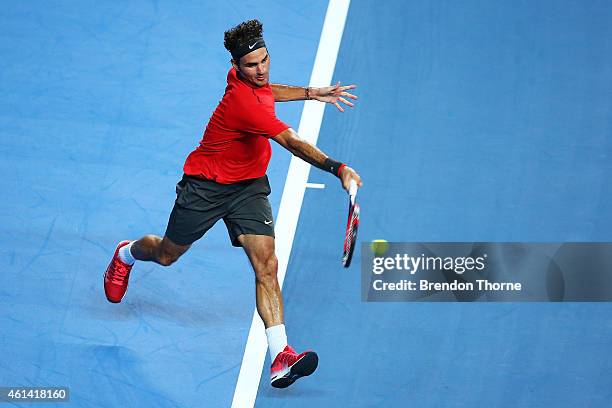 Roger Federer of Switzerland plays a forehand against Lleyton Hewitt of Australia during their match at Qantas Credit Union Arena on January 12, 2015...