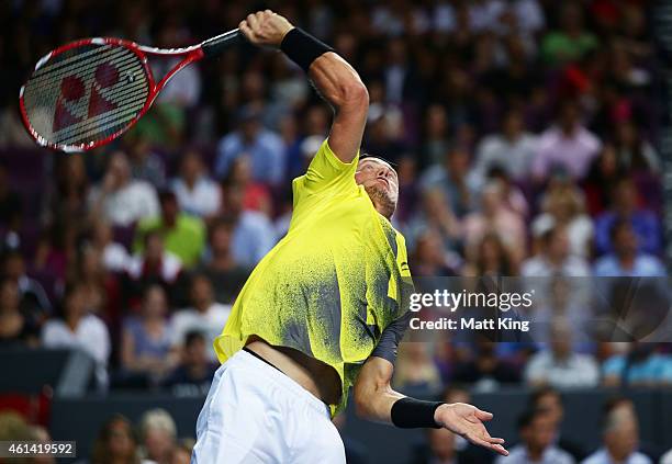 Lleyton Hewitt of Australia serves against Roger Federer of Switzerland during their match at Qantas Credit Union Arena on January 12, 2015 in...