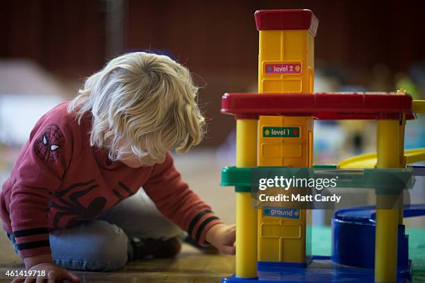 Young boy plays with toys at a playgroup for pre-school aged children in Chilcompton near Radstock on January 6, 2015 in Somerset, England. Along...