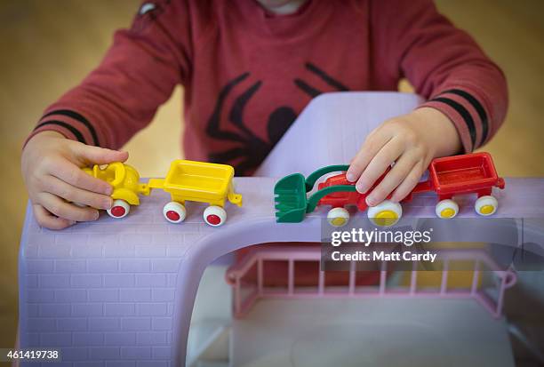 Young boy plays with toys at a playgroup for pre-school aged children in Chilcompton near Radstock on January 6, 2015 in Somerset, England. Along...