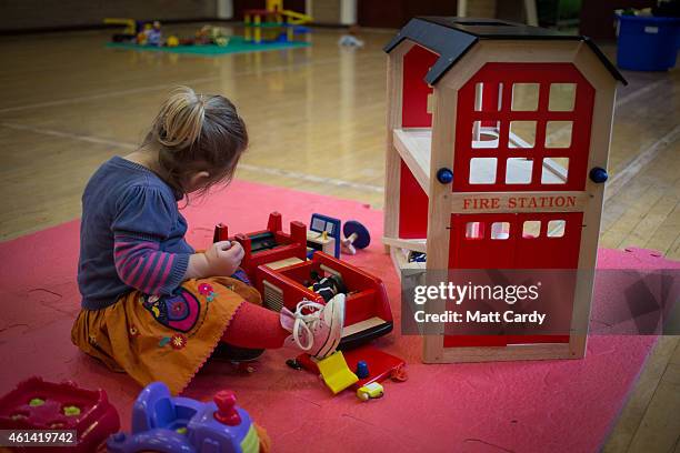 Young girl plays with toys at a playgroup for pre-school aged children in Chilcompton near Radstock on January 6, 2015 in Somerset, England. Along...