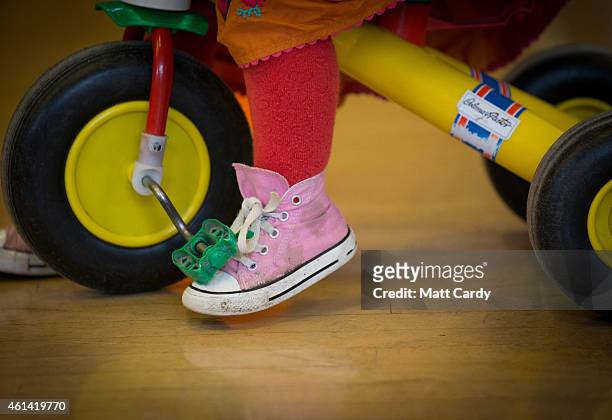 Toddler rides a bike at a playgroup for pre-school aged children in Chilcompton near Radstock on January 6, 2015 in Somerset, England. Along with the...