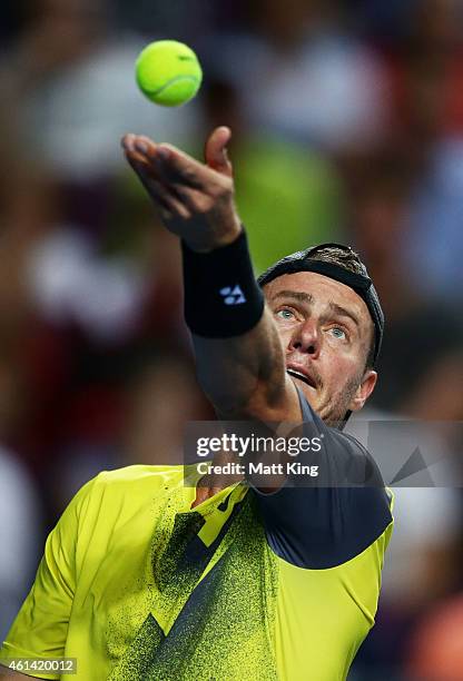 Lleyton Hewitt of Australia serves against Roger Federer of Switzerland during their match at Qantas Credit Union Arena on January 12, 2015 in...