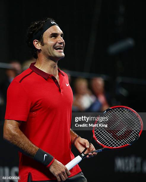 Roger Federer of Switzerland smiles against Lleyton Hewitt of Australia during their match at Qantas Credit Union Arena on January 12, 2015 in...