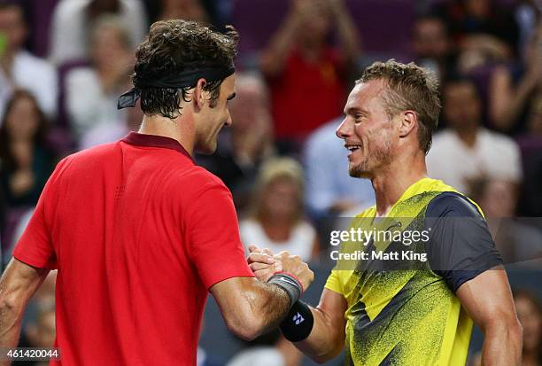 Roger Federer of Switzerland shakes hands with Lleyton Hewitt of Australia after their match at Qantas Credit Union Arena on January 12, 2015 in...