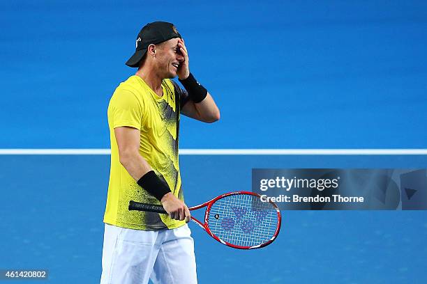 Lleyton Hewitt of Australia reacts after losing a point against Roger Federer of Switzerland during their match at Qantas Credit Union Arena on...