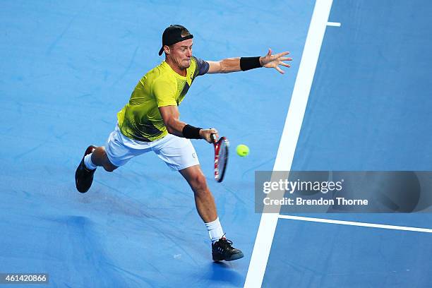 Lleyton Hewitt of Australia plays a forehand against Roger Federer of Switzerland during their match at Qantas Credit Union Arena on January 12, 2015...