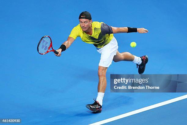 Lleyton Hewitt of Australia plays a forehand against Roger Federer of Switzerland during their match at Qantas Credit Union Arena on January 12, 2015...