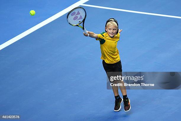 Lleyton Hewitt's son, Cruz Lleyton Hewitt plays a forehand against Roger Federer of Switzerland in the warm up prior to his Dad's match at Qantas...