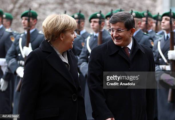 German Chancellor Angela Merkel welcomes Turkish Prime Minister Ahmet Davutoglu with the military honor ceremony upon Davutoglu's arrival for talks...