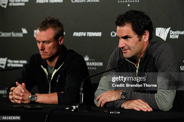 Roger Federer of Switzerland and Lleyton Hewitt of Australia speak to the media following their match at Qantas Credit Union Arena on January 12,...