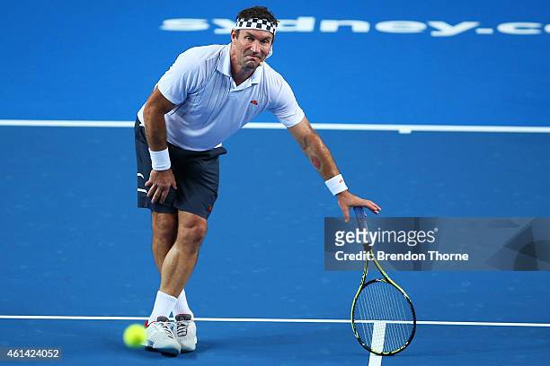 Pat Cash of Australia jokes around during a Fast4 Legends tennis doubles exhibition match prior to the Roger Federer and Lleyton Hewitt match at...