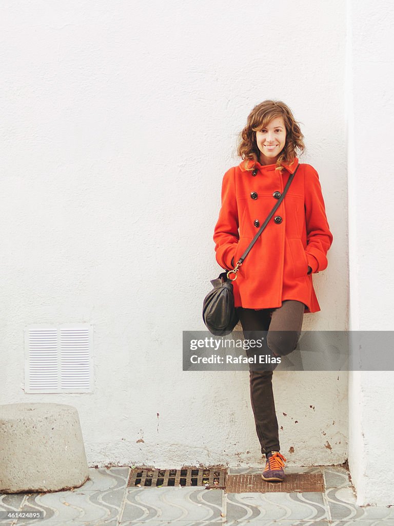 Pretty woman leaning on wall