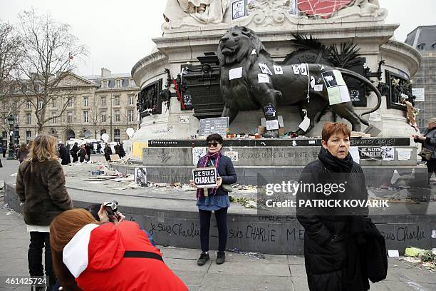 Tourists take pictures on the Place de la Republique on January 12, 2015 in Paris the day after marches that drew nearly four million people across...