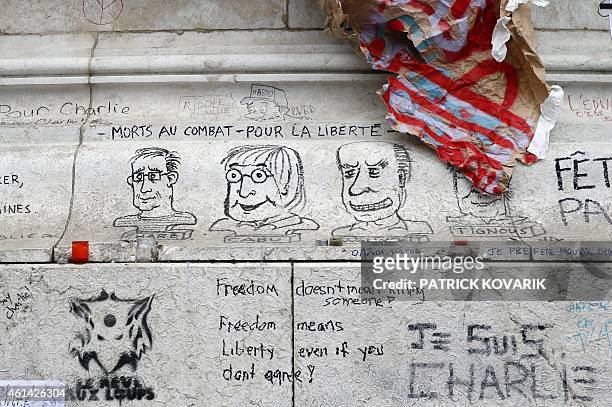 Graffitis are pictured on the Place de la Republique on January 12, 2015 in Paris the day after marches that drew nearly four million people across...