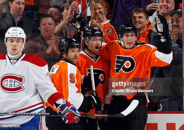 Sean Couturier of the Philadelphia Flyers celebrates his first period goal against the Montreal Canadiens along with Steve Downie and Vincent...