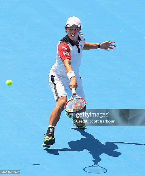 Kei Nishikori of Japan plays a backhand during his match against Tomas Berdych of the Czech Republic during day two of the AAMI Classic at Kooyong on...