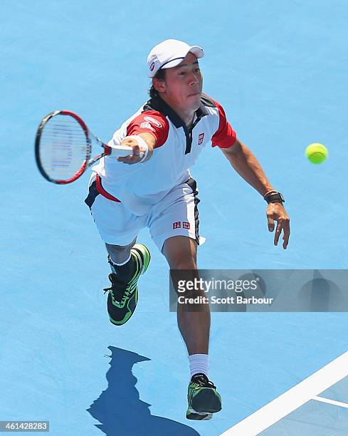 Kei Nishikori of Japan plays a forehand during his match against Tomas Berdych of the Czech Republic during day two of the AAMI Classic at Kooyong on...