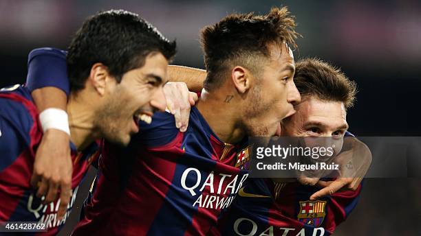 Lionel Messi of FC Barcelona celebrates scoring his team's third goal with team-mates Neymar and Luis Suarez during the La Liga match between FC...