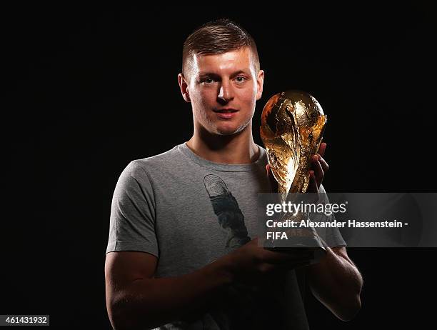 Toni Kroos of Germany poses with the FIFA World Cup Trophy prior to the FIFA Ballon d'Or Gala 2014 at the Park Hyatt hotel on January 12, 2015 in...