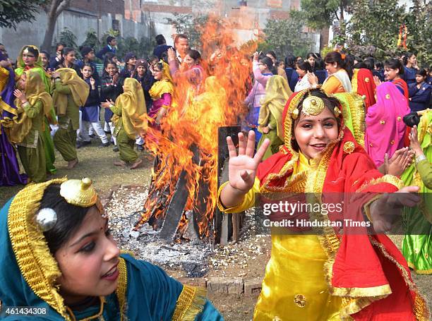School girls wearing traditional Punjabi dresses perform Giddha dance on the eve of Lohri festival at Jagat Jyoti School Jora Phatak on January 12,...