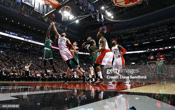 Jonas Valanciunas of the Toronto Raptors reaches for the ball against Jae Crowder of the Boston Celtics at the Air Canada Centre on January 10, 2015...