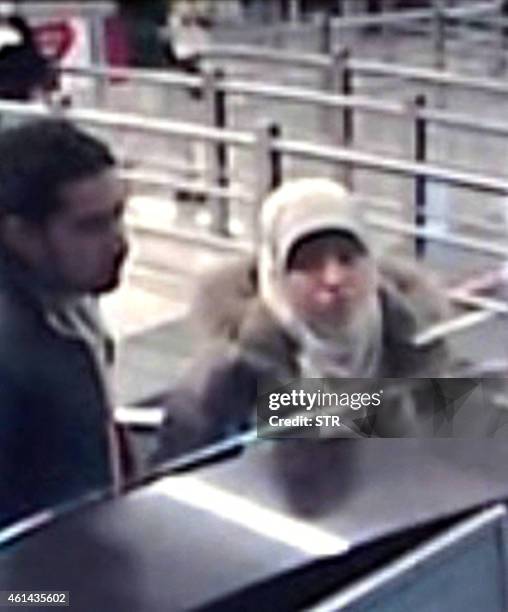 This photo distributed on January 12, 2015 by the Turkish Ihlas News Agency shows Hayat Boumeddiene presenting her passport at Sabiha Gokcen airport...