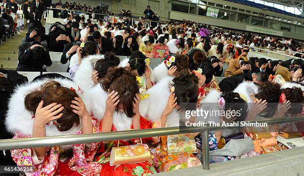 New twenty-year-old protect their heads as a part of emergency exercise as 20th anniversary of the 1995 Great Hanshin Earthquake approaching during...