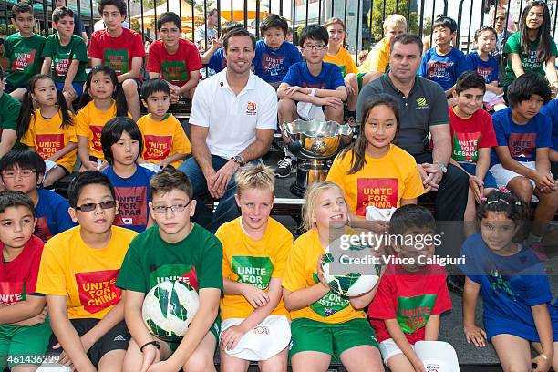 Socceroos Captain Lucas Neill and coach Ange Postecoglou pose with the Asia Cup trophy and a range of multicultural children during the AFC Asian Cup...