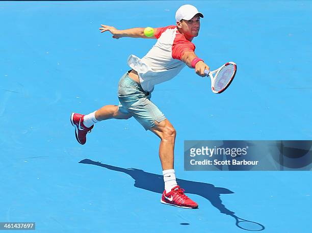 Grigor Dimitrov of Bulgaria plays a backhand during his match against Fernando Verdasco of Spain during day two of the AAMI Classic at Kooyong on...