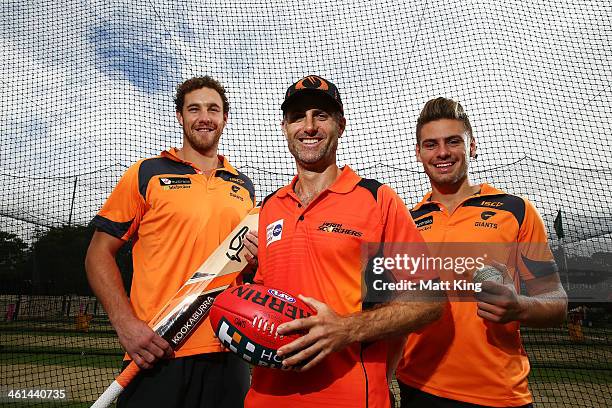 Shane Mumford and Stephen Coniglio of the Greater Western Sydney Giants pose with Simon Katich of the Scorchers during a Perth Scorchers Big Bash...